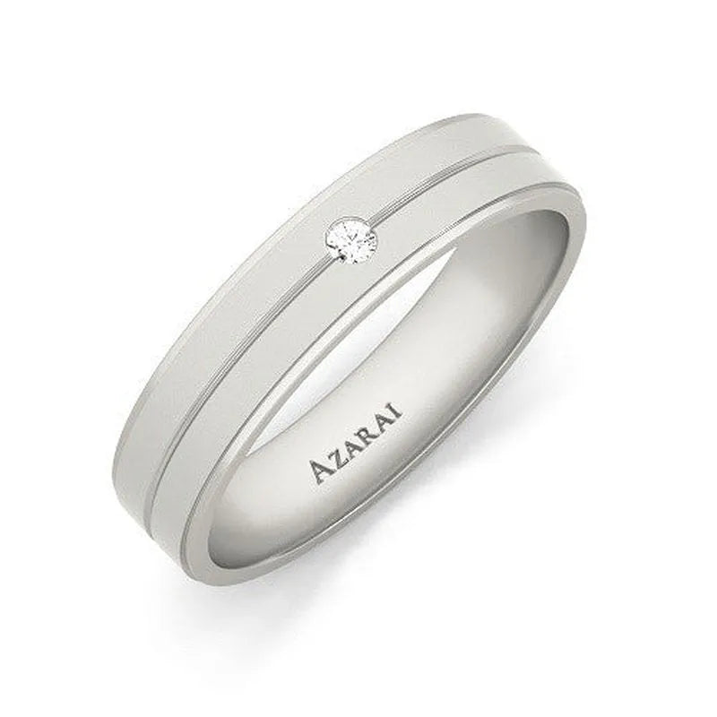 The Aria sterling silver wedding band, featuring a small diamond and two engraved lines with "AZARAI" inscribed inside, is available on clearance as a final sale item.