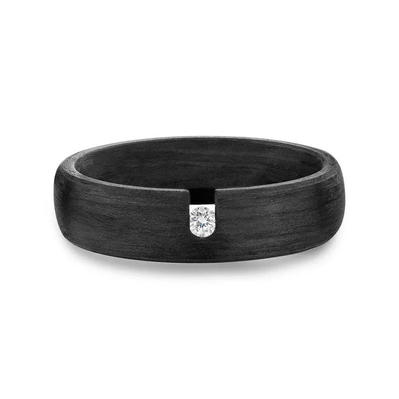 Introducing the Khoal carbon fibre wedding band, a sleek black ring for men featuring a single round diamond elegantly set on top, crafted from durable carbon fibre.