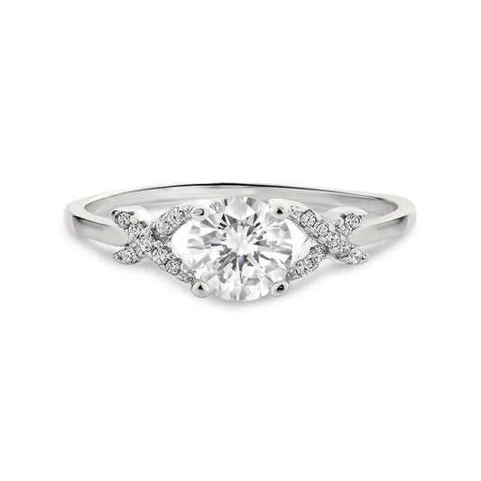 The Rosetta sterling silver engagement ring features a solitaire round-cut center stone, accented by smaller diamonds arranged in an elegant "X" design on each side.