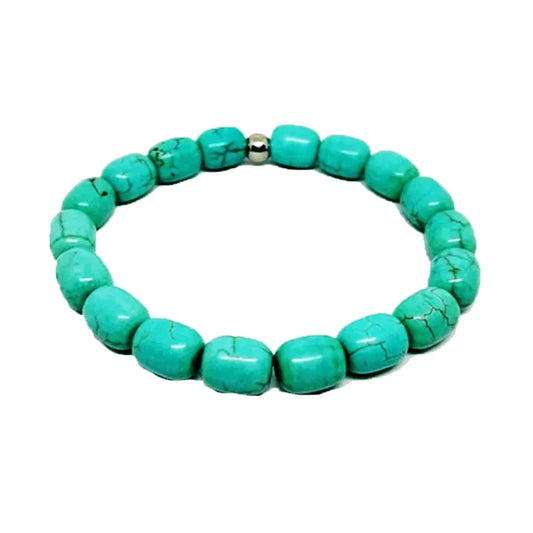 The Verdis turquoise beaded men's bracelet showcases semi-precious turquoise beads with a sleek silver clasp, skillfully arranged in a perfect circular shape.