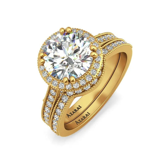 Solara 9kt gold bridal set featuring a stunning gold ring with a large round diamond and smaller diamonds encrusted around and alongside the band. The inner side of the 9kt gold band is engraved with "AZARAN.