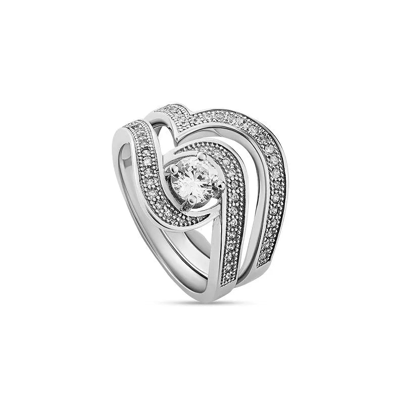 Introducing the Katrina sterling silver bridal set, now on clearance, showcasing a breathtaking central diamond on a silver ring. This elegant ensemble is complemented by two gracefully curved bands adorned with diamonds, all expertly crafted in stunning sterling silver.