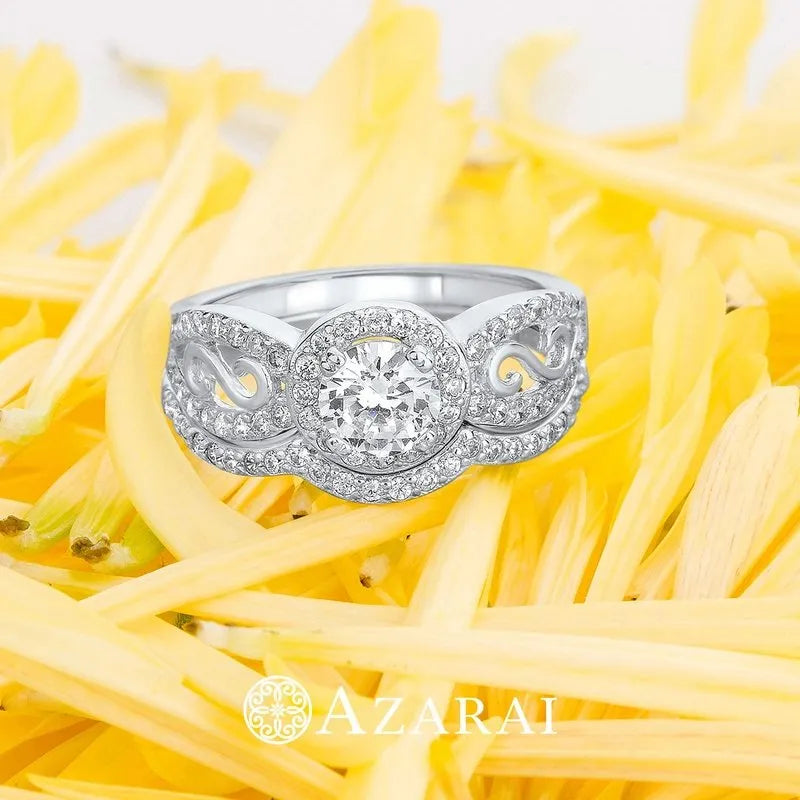 The Miele sterling silver bridal set features a ring with a central round diamond elegantly placed on a bed of yellow flower petals.