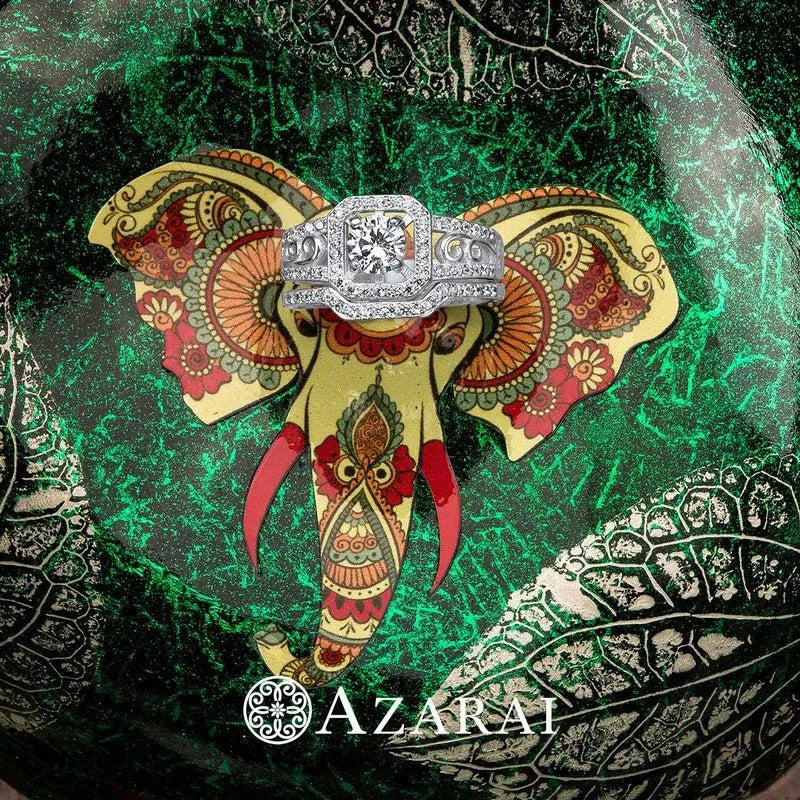 The detailed elephant design features a sterling silver ring at the center against a green textured background, with the Azarai logo visible at the bottom. Product: Paris Sterling Silver Bridal Set ON CLEARANCE.