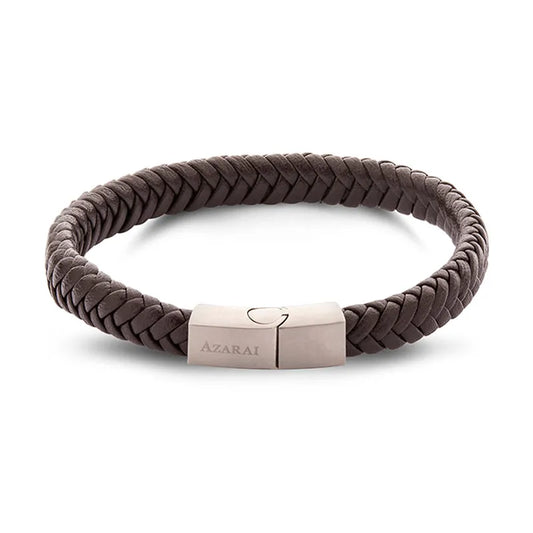 The Sabre leather bracelet for men is an exquisite brown braided piece featuring a metallic clasp engraved with "Azarai." Ideal for gifting, it arrives in elegant gift packaging and is available for nationwide delivery.