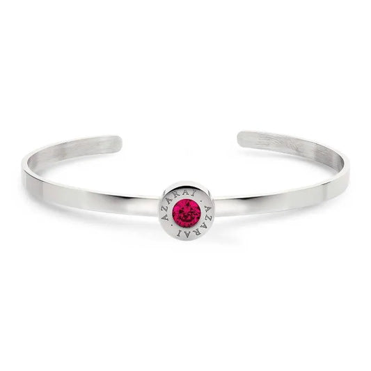 The Varia birthstone women's bracelet features a sophisticated silver cuff adorned with a centrally set round pink gemstone. The distinctive engraving of "AZARAI" encircles the birthstone, giving this stunning piece its unique charm.