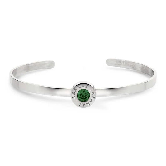 Introducing the Varia birthstone women's bracelet: a silver cuff adorned with a round green gemstone at its center, beautifully encircled by the engraved word “AZARAI.”