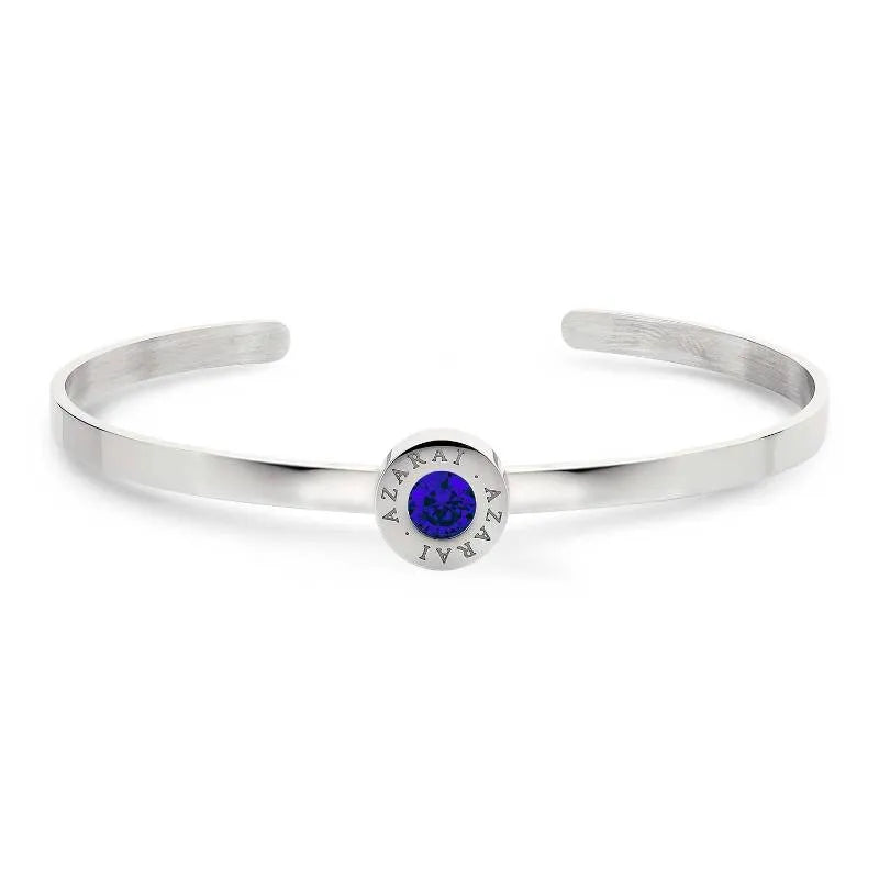 Varia birthstone women's bracelet features a round blue gem at its center, elegantly engraved with "AZARAI.