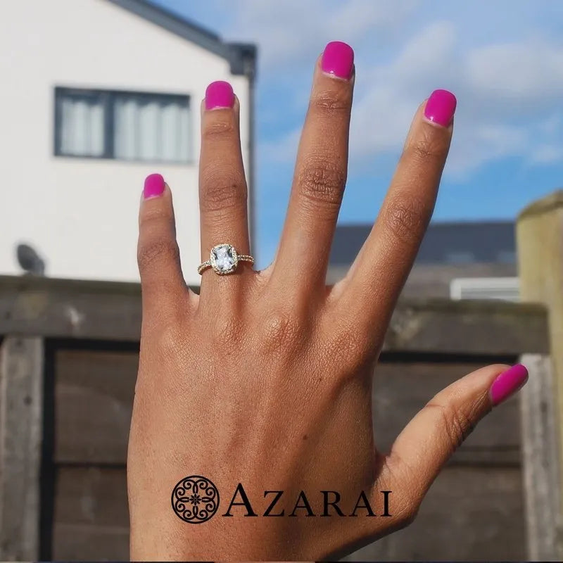 Adeline's hand with pink nail polish elegantly showcases the Adeline 9kt gold engagement ring, featuring a dazzling diamond.