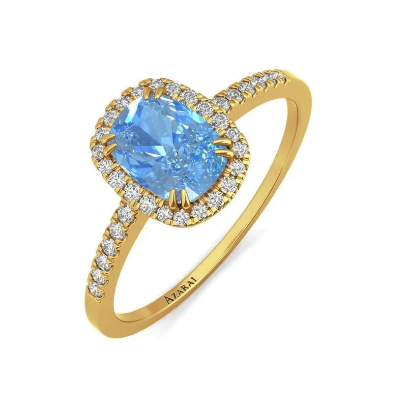 The Adeline 9kt gold engagement ring showcases a breathtaking large blue gemstone, elegantly accented by glistening diamonds along the band.