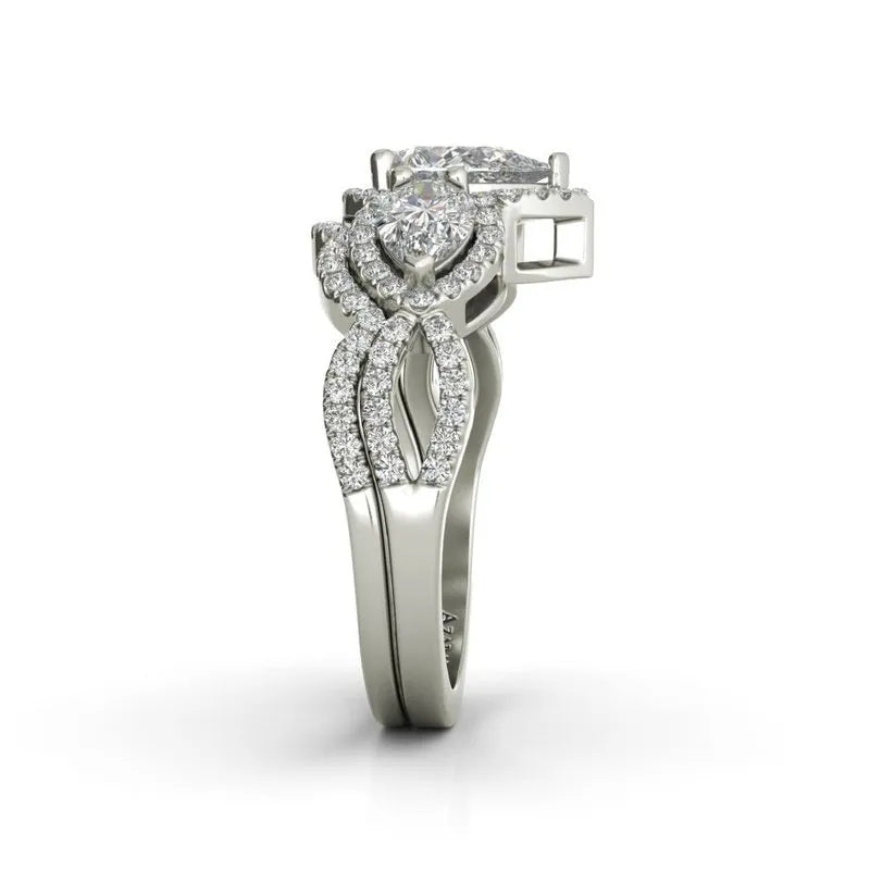 The Alyssa sterling silver bridal set is an exquisite piece featuring intertwined bands with a large central diamond and smaller diamonds along the bands, beautifully complementing any engagement ring.