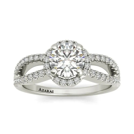 The Angelika sterling silver engagement ring on clearance showcases a prominent central round diamond, accented by smaller diamonds on a sophisticated twisted band. This piece combines timeless elegance with outstanding value.