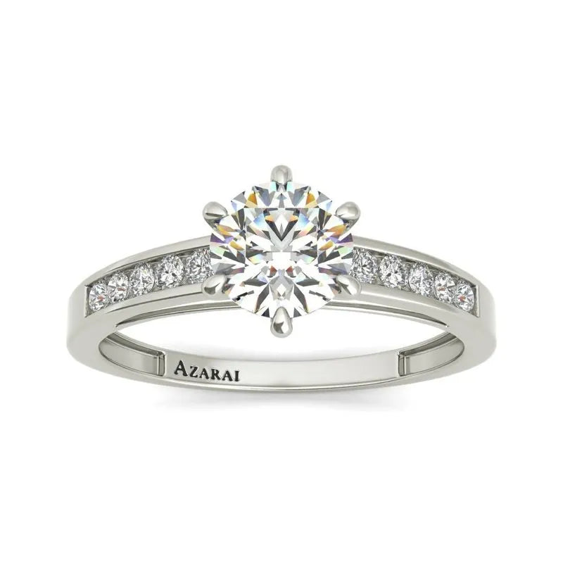 The Anna engagement ring showcases a stunning central diamond set in a 9kt gold band adorned with smaller diamonds, all exquisitely engraved with "AZARAI.