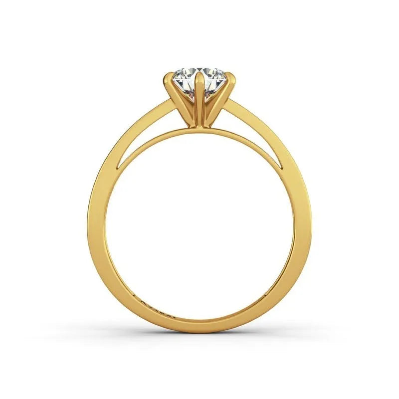 The Anna 9kt gold engagement ring highlights a round diamond elegantly positioned in a prong setting, beautifully viewed from the side, exuding timeless beauty.