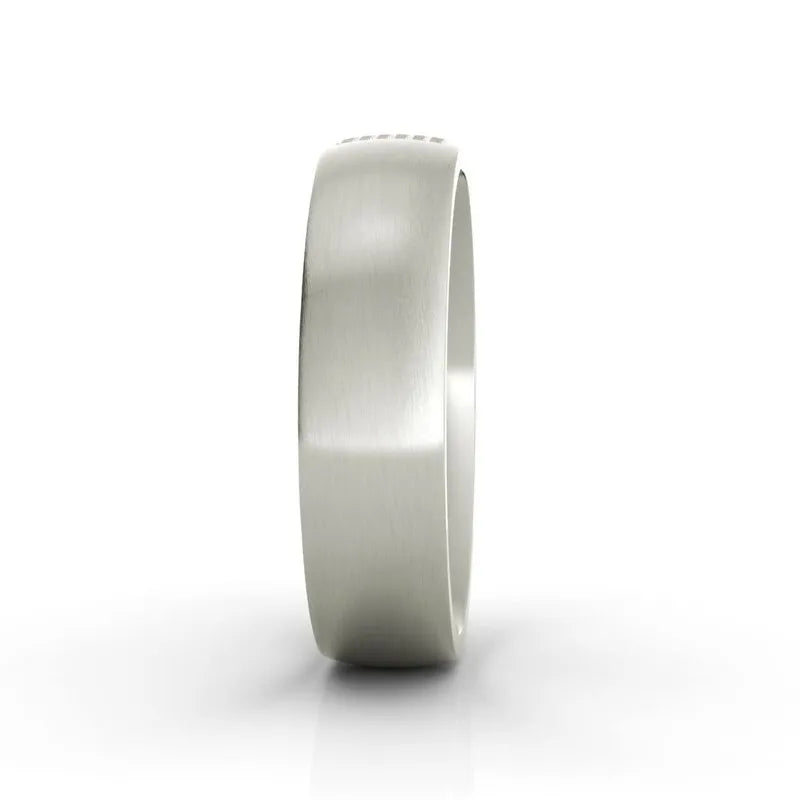 The Aspen sterling silver wedding band, featuring a smooth matte finish, stands upright against a white background, embodying elegance.