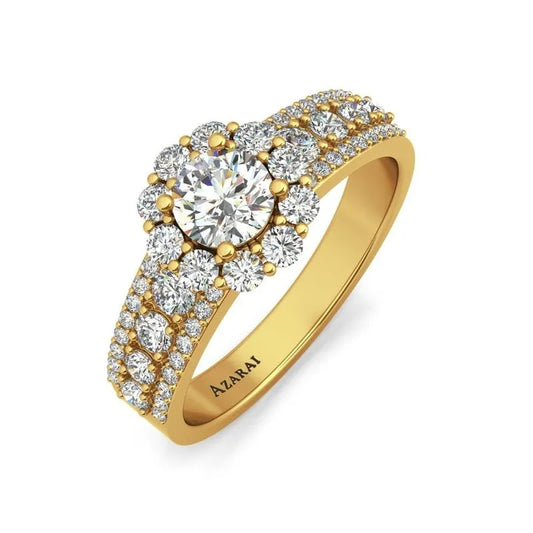 Introducing the Auburn 9kt gold engagement ring, a breathtaking piece showcasing a round central diamond surrounded by a halo of sparkling smaller diamonds, complemented by a double band adorned with additional radiant stones.