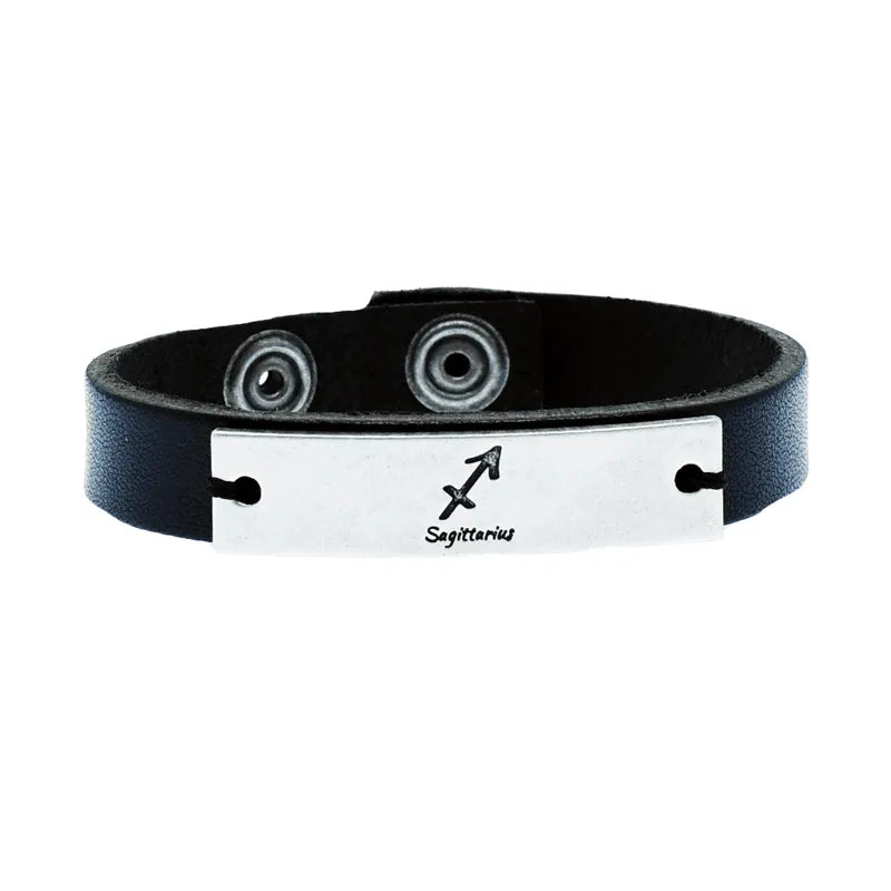 The Elemento leather men's bracelet showcases a metal plate engraved with the Sagittarius zodiac symbol and text, fastened with two snap buttons for a secure fit.