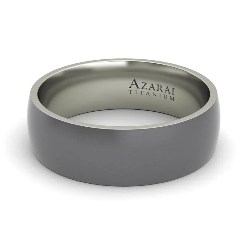 A sleek, metallic men's wedding band with "Baylor Titanium" engraved on the inside.