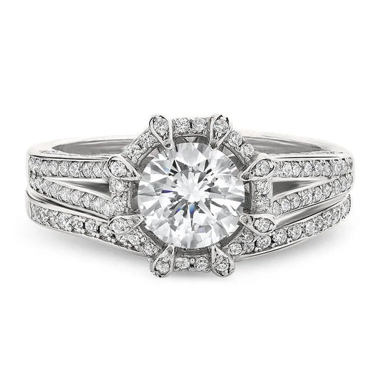 The Britney sterling silver bridal set ON CLEARANCE showcases a large round diamond with a halo and split shank band adorned with smaller diamonds, elegantly presented in an Azarai ring box.