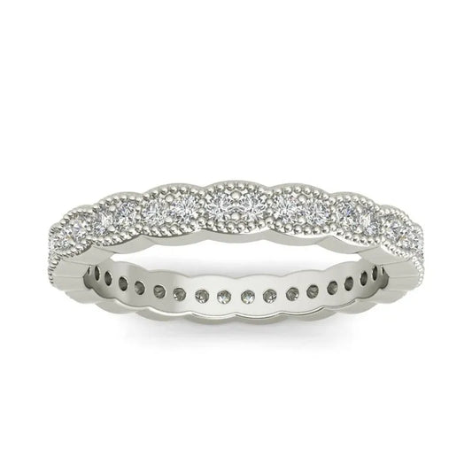 The Carlotta sterling silver wedding band showcases a pattern of small round diamonds set in an alternating swirl design encircling the band, making it an ideal choice for a wedding or as an elegant accessory for any occasion.