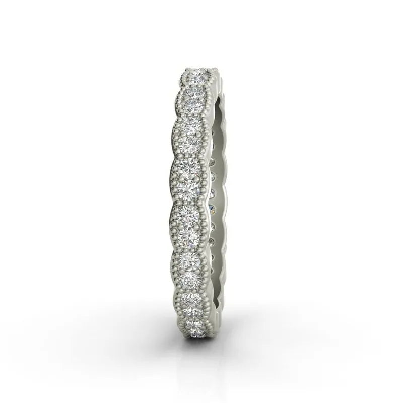 Presenting the Carlotta sterling silver wedding band: a captivating ring beautifully embellished with a row of small, round diamonds set along the top half, ideal for sealing your vows with timeless brilliance.