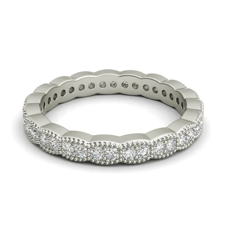 The Carlotta sterling silver wedding band features a scalloped design with small, round diamonds encircling it, making it an ideal choice for a wedding band.