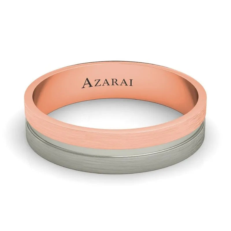 The Chandler 18kt gold wedding band combines a striking two-toned design with a rose gold interior and a silver exterior, elegantly engraved with "AZARAI" on the inside.