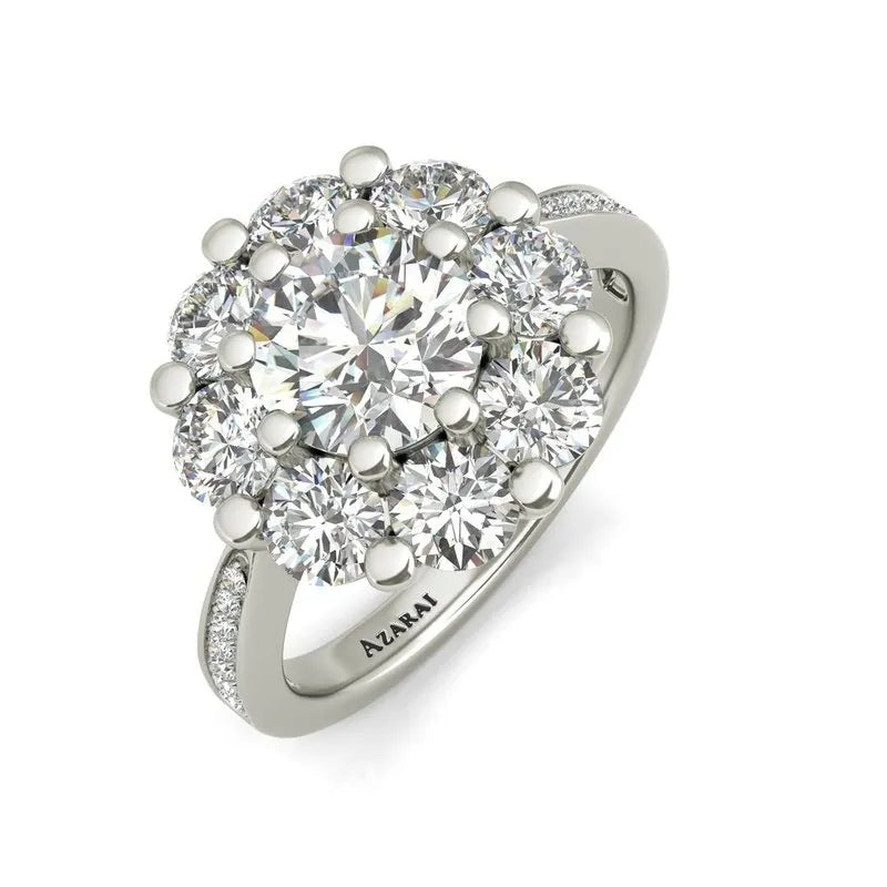 The Charlotte sterling silver engagement ring, now on clearance, showcases a striking large diamond at its center surrounded by smaller diamonds. The band is embellished with additional diamond accents, making it an elegant choice for an engagement ring. Get elegance without compromise today.