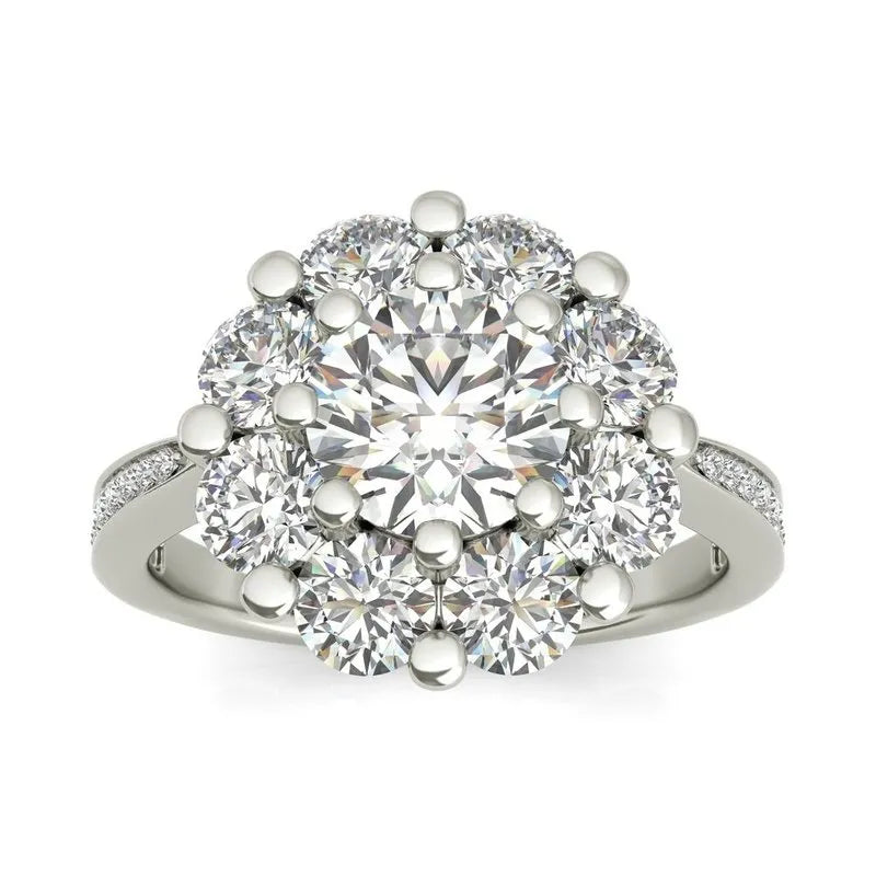 The Charlotte sterling silver engagement ring, currently on clearance, features a stunning central diamond surrounded by smaller diamonds, all beautifully set on a sterling silver band.