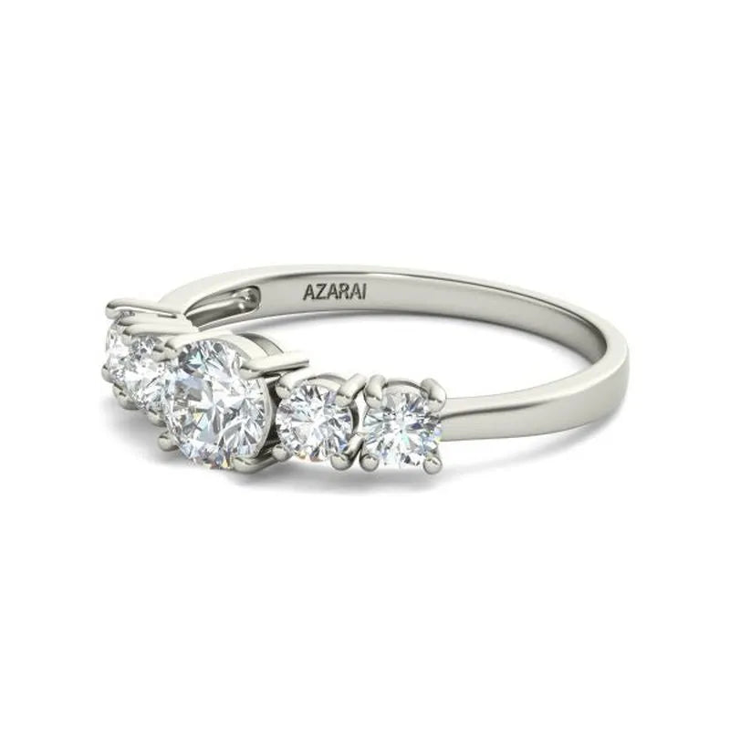 An elegant engagement ring crafted from Circa 9kt gold, featuring five round-cut diamonds set in a row and engraved with the word "AZARAI" on the band, highlighting its timeless appeal.