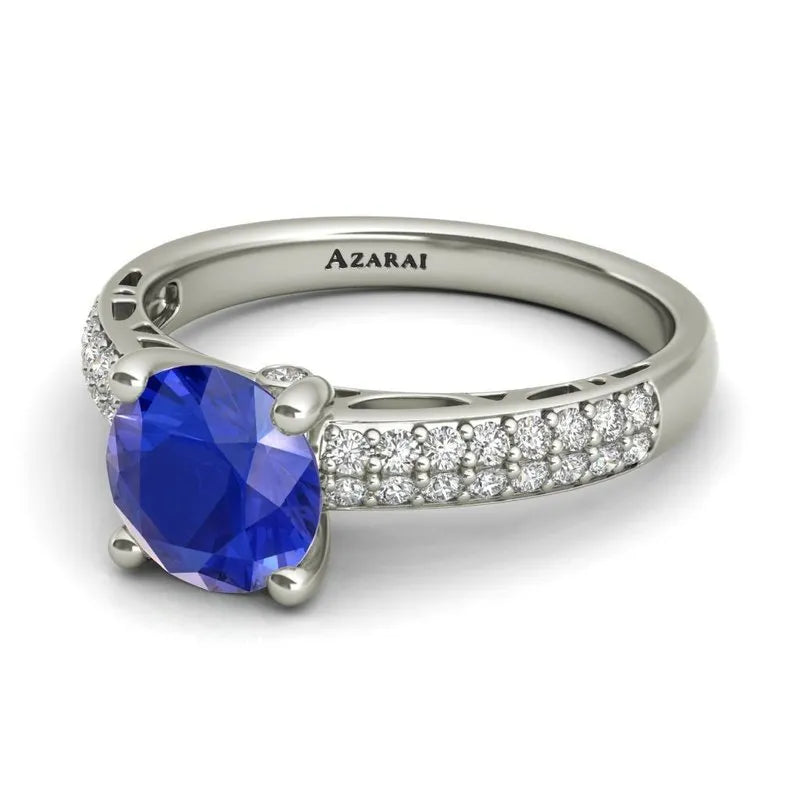 Explore the Dakota sterling silver engagement ring now on clearance, ideal for the modern bride. This stunning piece showcases a large blue gemstone and small diamonds along the band, with a hidden diamond detail adding an extra touch of elegance.