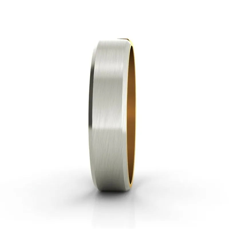 The Eclipse 18kt gold wedding band, a premium men's piece featuring a stunning dual-tone design in silver and 18kt gold, showcases a brushed finish as it stands upright against a plain white background.