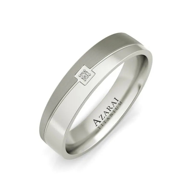 The Eli titanium wedding band is a silver men's ring with a small square diamond design engraved and the brand name "AZARAI" on the interior.