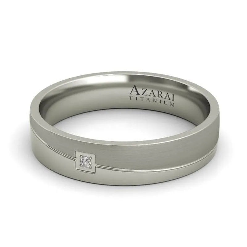 Eli titanium wedding band for men, showcasing a small square design with an embedded gem, engraved with "Azarai Titanium.