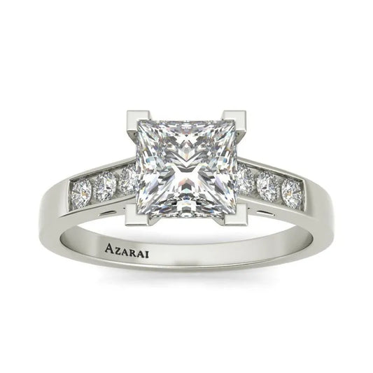 The Erisa sterling silver engagement ring, featuring a stunning large square-cut diamond at its center and beautifully accented with smaller round diamonds on each side, is an exquisite piece you won't want to miss. Available now in the clearance section—it's on final sale!