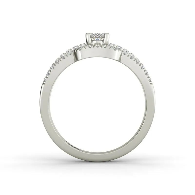 The Esmee sterling silver engagement ring, currently on clearance, showcases a dazzling solitaire diamond perched atop the band and is complemented by small diamonds elegantly set around the sterling silver band.