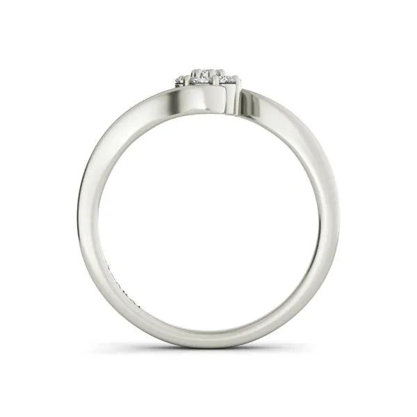 The Fleur sterling silver engagement ring showcases a refined circular cluster of diamonds on top, resembling a Fleur when viewed from the side.