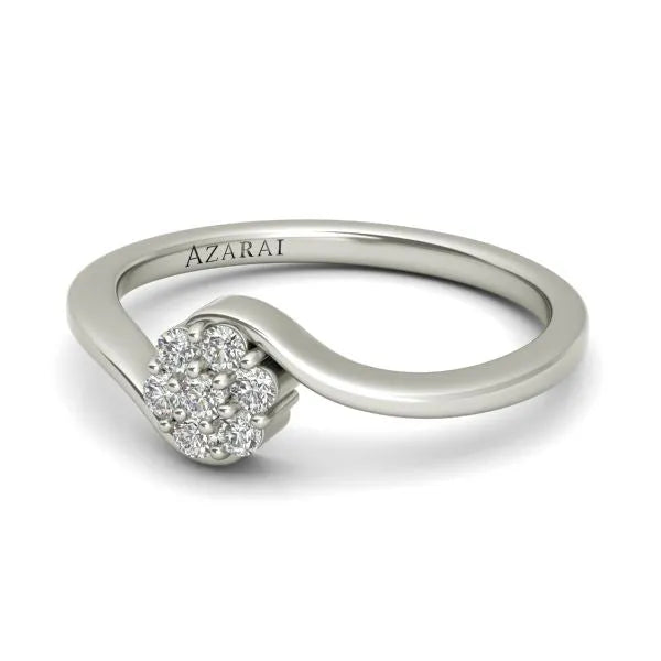 The Fleur sterling silver engagement ring boasts a twisted band design adorned with a cluster of small round diamonds on top and is engraved with "AZARAI." This elegant piece embodies grace and charm, making it an ideal choice for an engagement ring.