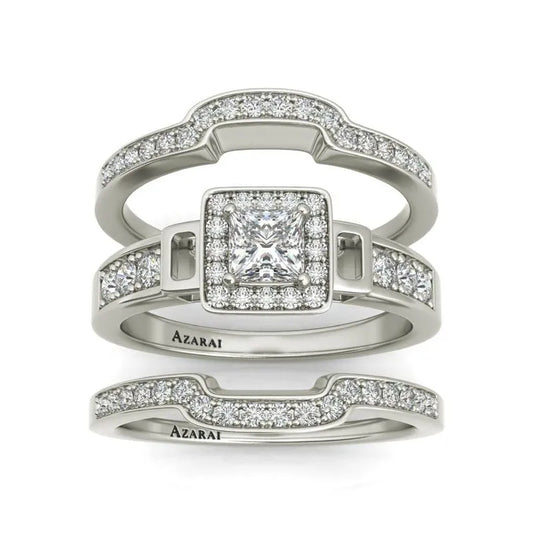 The Henriette sterling silver bridal set, now on clearance, includes three stunning rings embellished with embedded diamonds. The centerpiece square, elegantly encircled by smaller diamonds, takes center stage, flanked by two matching bands below.