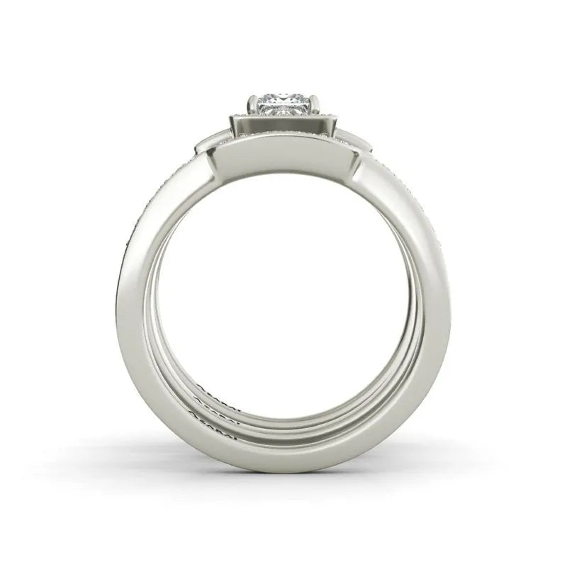 The Henriette sterling silver bridal set, currently on clearance, showcases a stunning ring adorned with a round diamond in an elegant prong setting, beautifully viewed from the side.