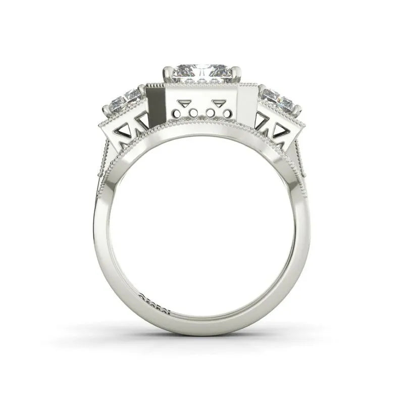 The Manhattan sterling silver bridal set features an engagement ring with three square-cut stones and intricate side detailing.