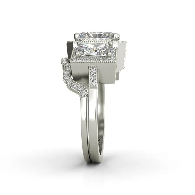 The Manhattan sterling silver bridal set features a prominent square-cut gemstone on top and a band adorned with smaller embedded stones, ideal for adding a touch of Manhattan sophistication.