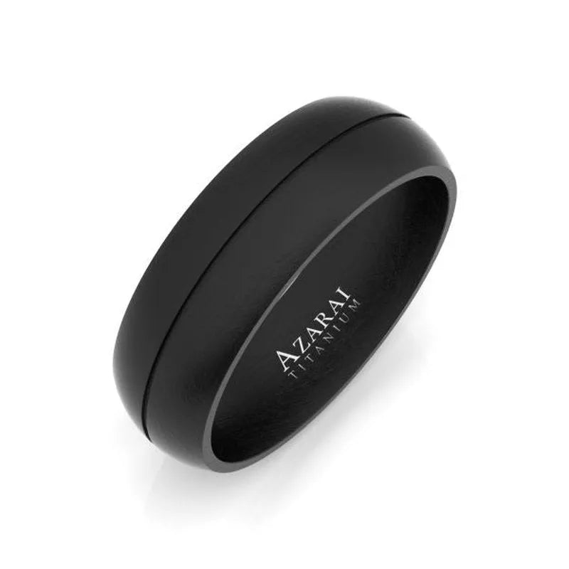 The Maverick black titanium wedding band, designed as a sleek men's ring, showcases a smooth matte finish and is gracefully engraved with "Azarai Titanium" on the inner band.