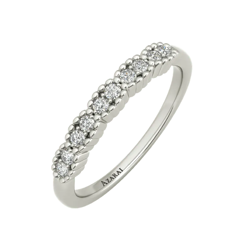 The Nina sterling silver wedding band features a row of small round diamonds and an engraving of the word "AIZRAI" on the inside, making it a stunning choice for a wedding band.