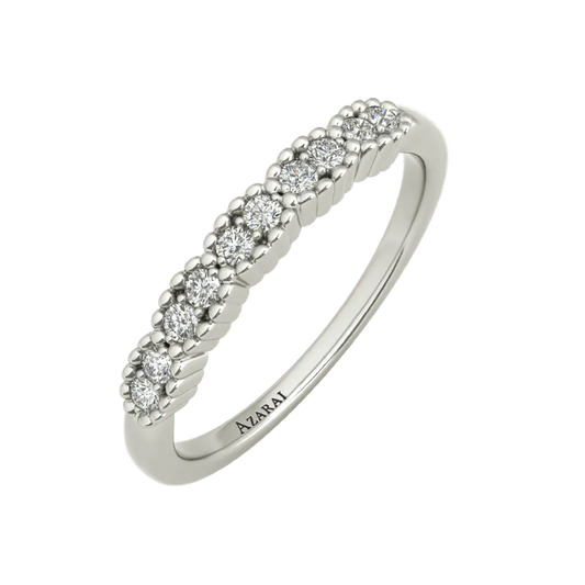 The Nina sterling silver wedding band features a row of small round diamonds and an engraving of the word "AIZRAI" on the inside, making it a stunning choice for a wedding band.