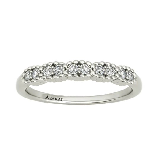 The Nina sterling silver wedding band features a series of small, sparkling diamonds on its band and is engraved with the word "Azarai" on the inside, making it an elegant choice for someone special.