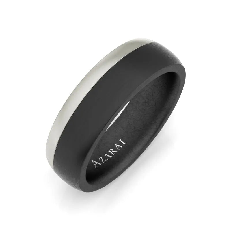 The Onyx carbon fibre wedding band is a sleek black accessory featuring a silver stripe and elegantly inscribed with the word "Azarai" inside, crafted to capture the rich allure of Onyx.