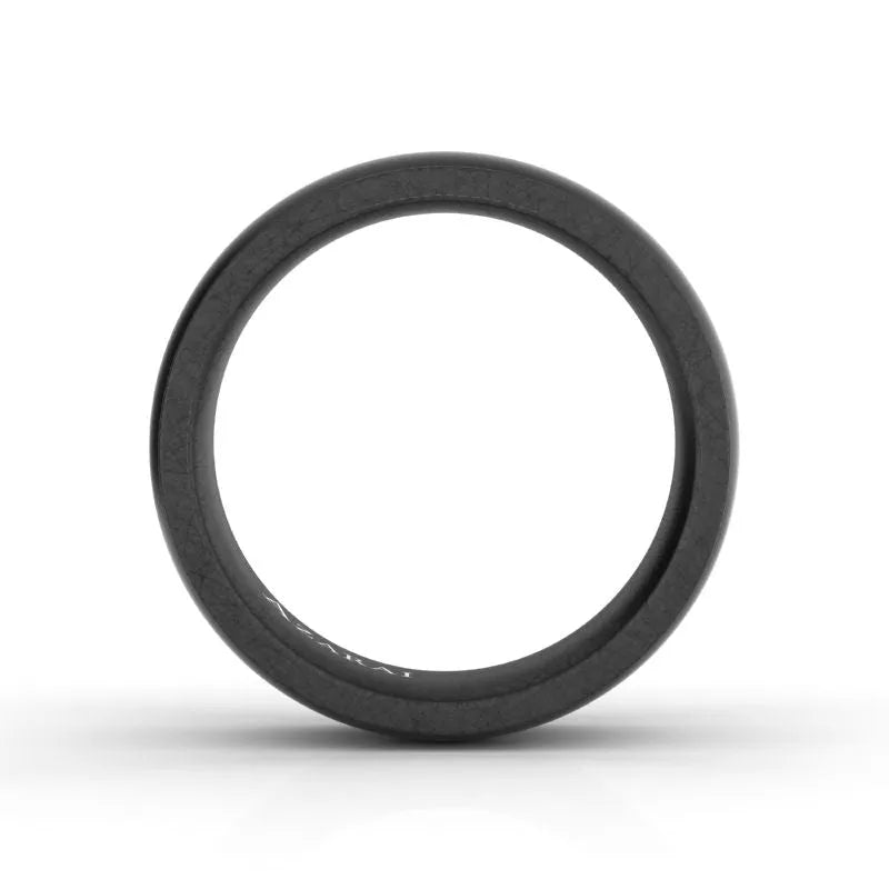 A slender Onyx Carbon Fibre Wedding Band featuring a smooth texture, positioned vertically against a white background.