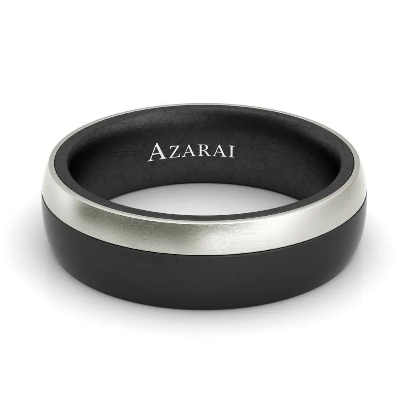 Introducing the Onyx carbon fibre wedding band, a stylish black ring featuring a silver stripe, crafted from durable carbon fibre with "AZARAI" elegantly engraved on the inside.