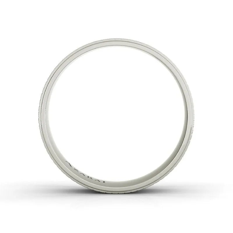 A sleek, white circular ring, reminiscent of a classic men's wedding band, graces the white background. The Parker sterling silver wedding band design adds a touch of modern elegance to this timeless piece.